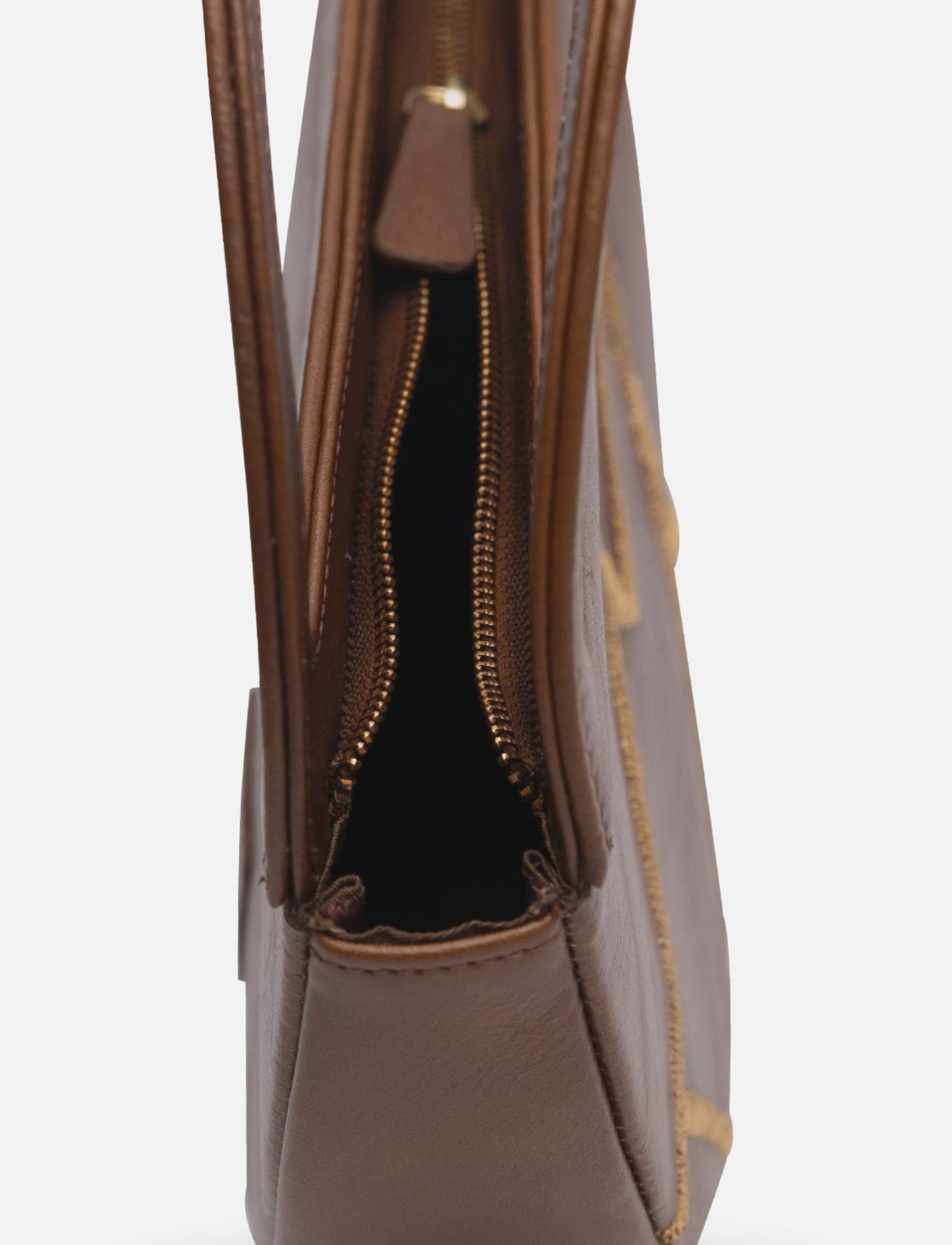 Upcycled and handcrafted leather handbag and clutch with gold embroidery in tan.