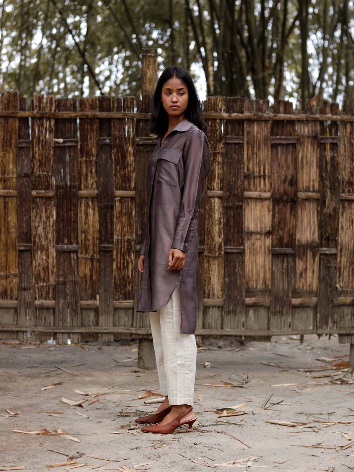 Long v neck slip-on grey-violet easy shirt with box pleat at back & asymmetrical hem, Relaxed Fit, Shell Buttons, Tea dyed Handwoven Chanderi Silk fabric.