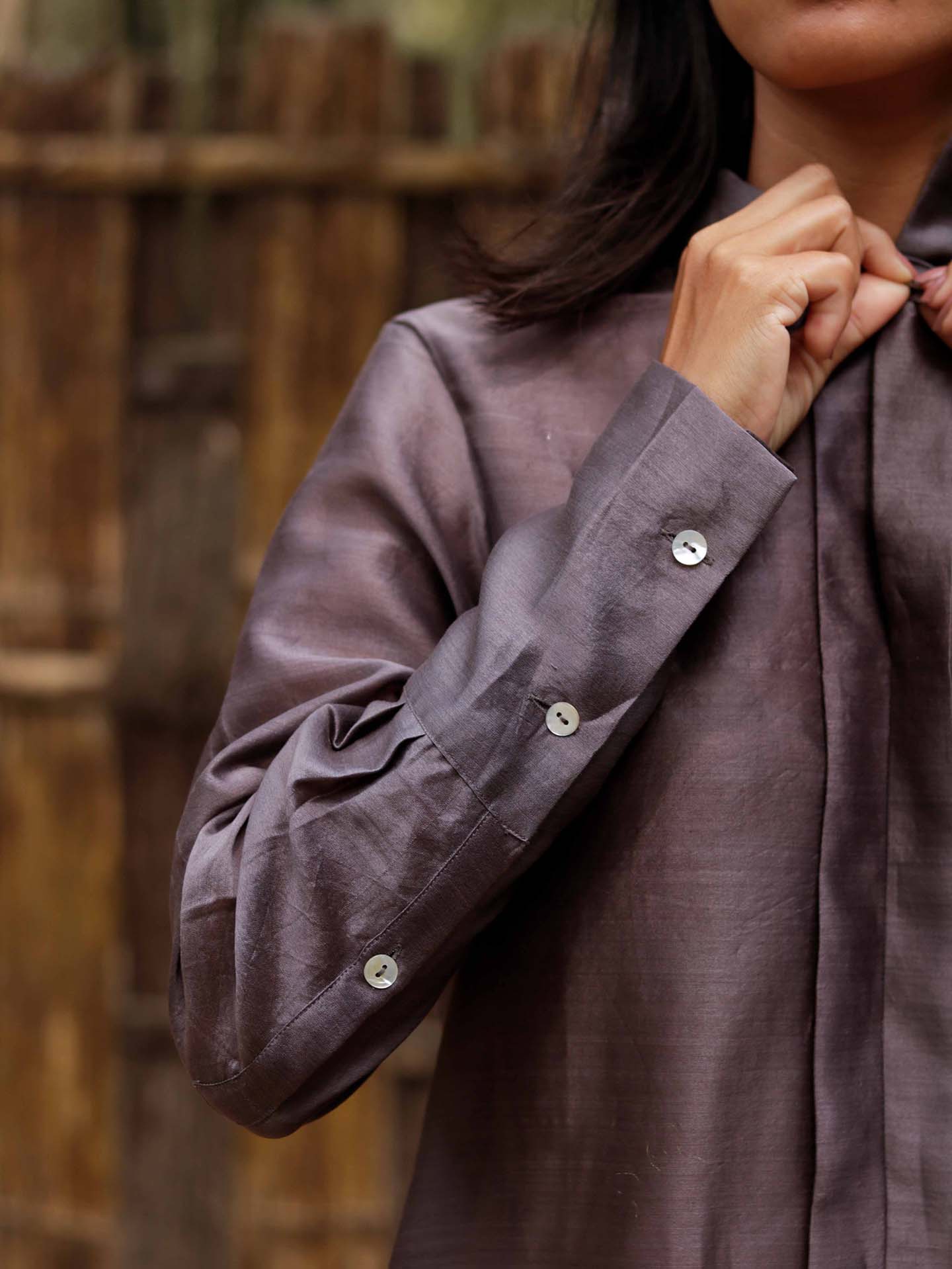 Long v neck slip-on grey-violet easy shirt with box pleat at back & asymmetrical hem, Relaxed Fit, Shell Buttons, Tea dyed Handwoven Chanderi Silk fabric.