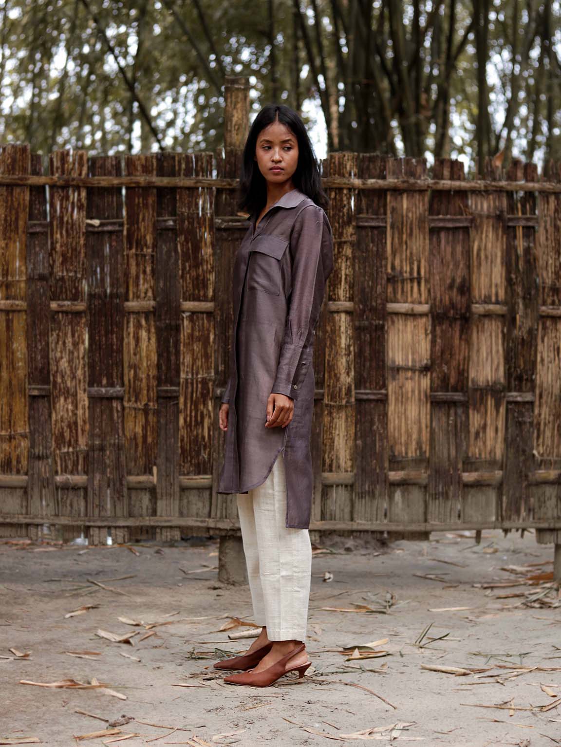 Long v neck slip-on grey-violet easy shirt with box pleat at back & asymmetrical hem, Relaxed Fit, Shell Buttons, Tea dyed Handwoven Chanderi Silk fabric. 