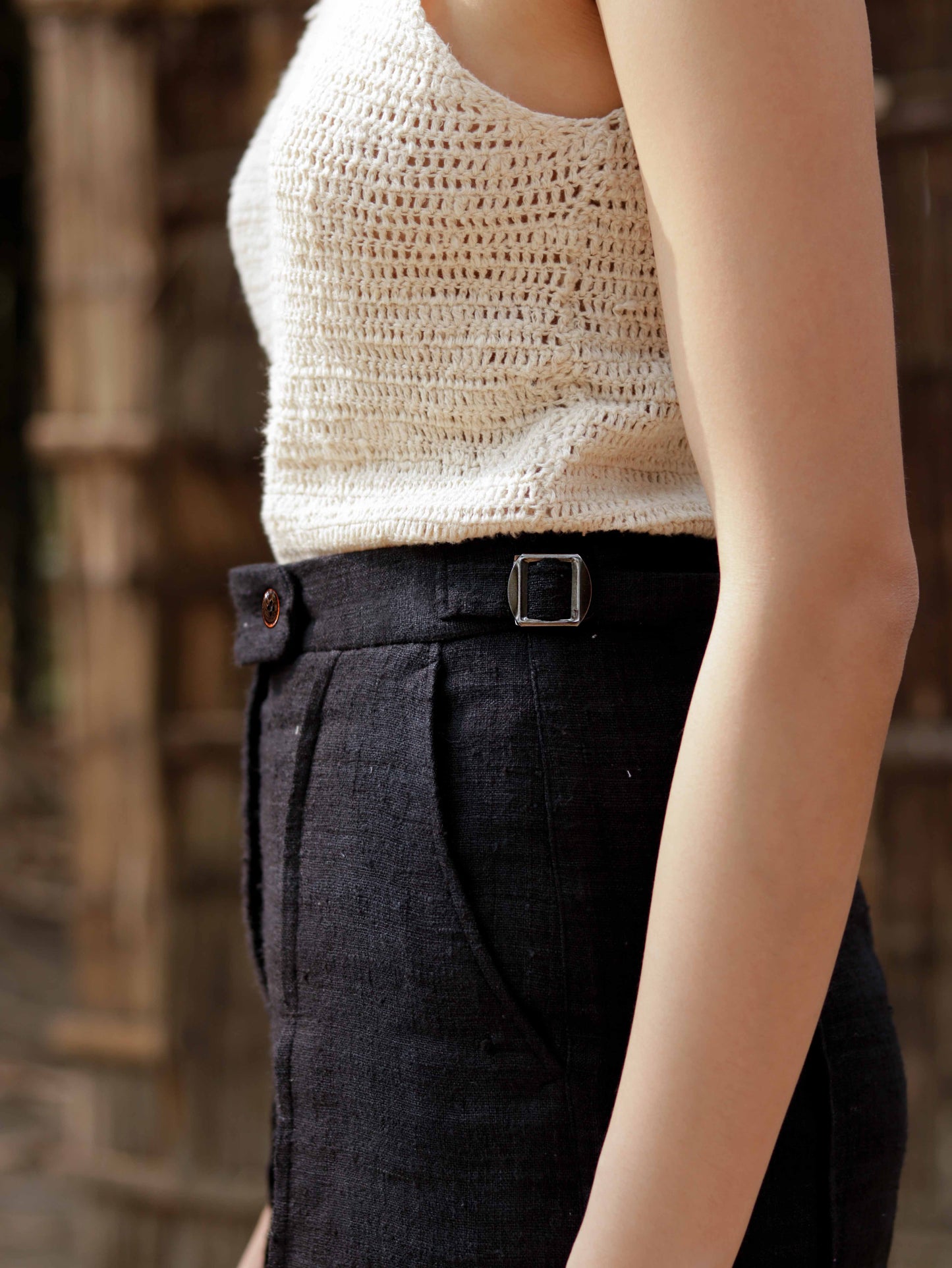 Eri explorer pants with pin-tuck at front crease and metal waistband adjusters.