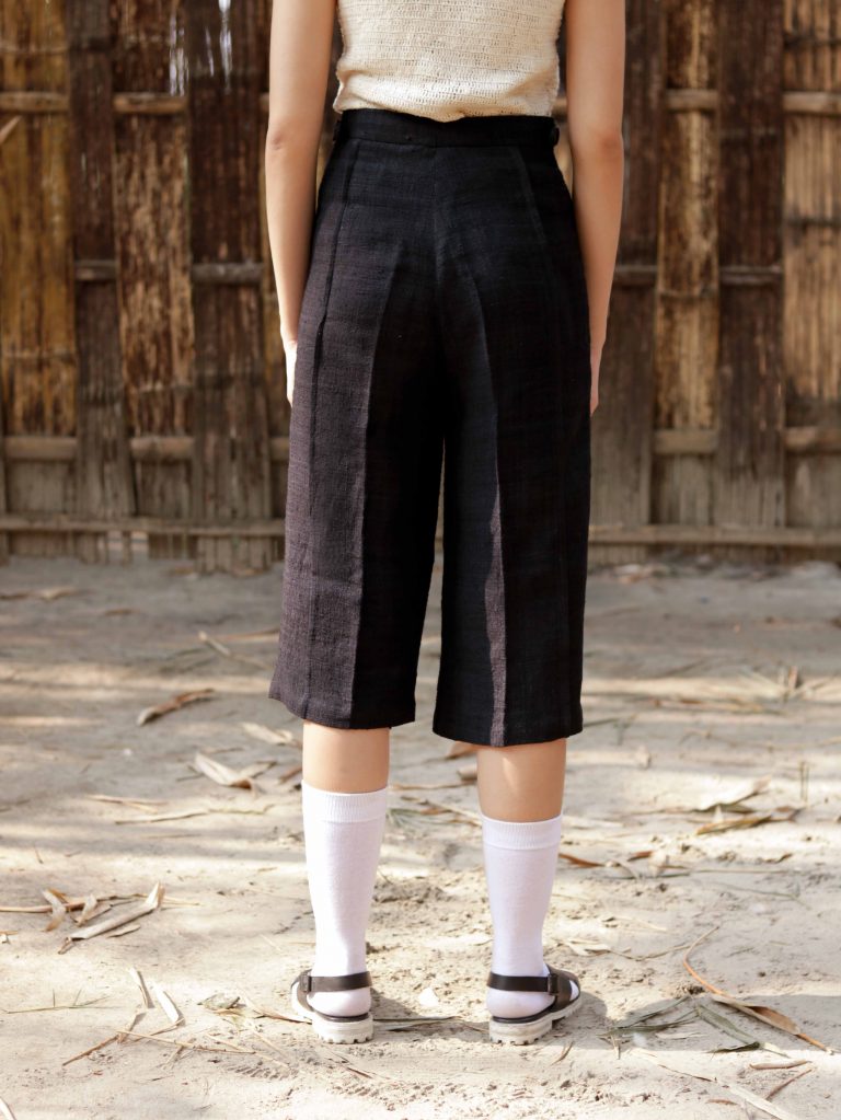 Eri explorer pants with pin-tuck at front crease and metal waistband adjusters.