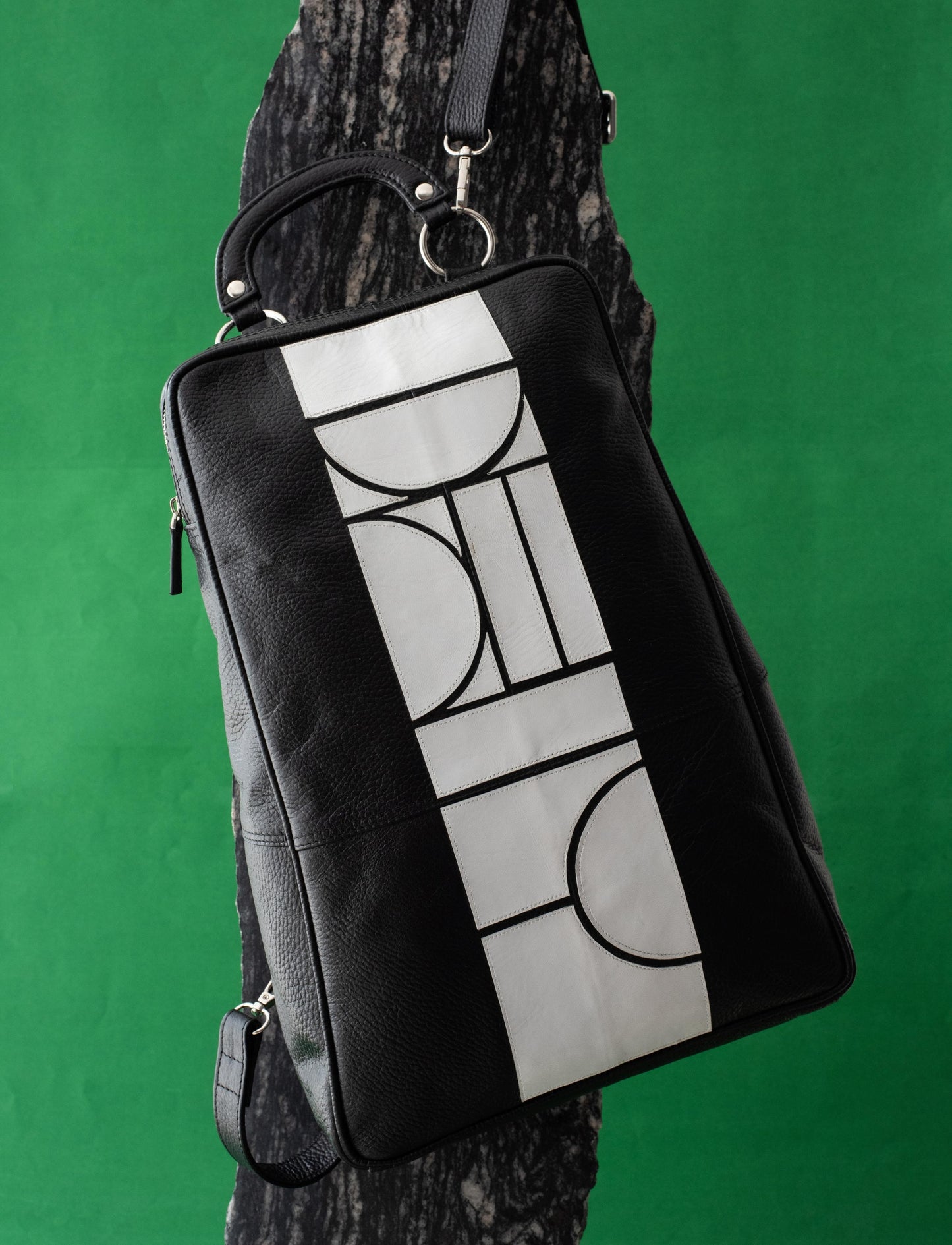 Black and white upcycled leather adjustable unisex bagpack.